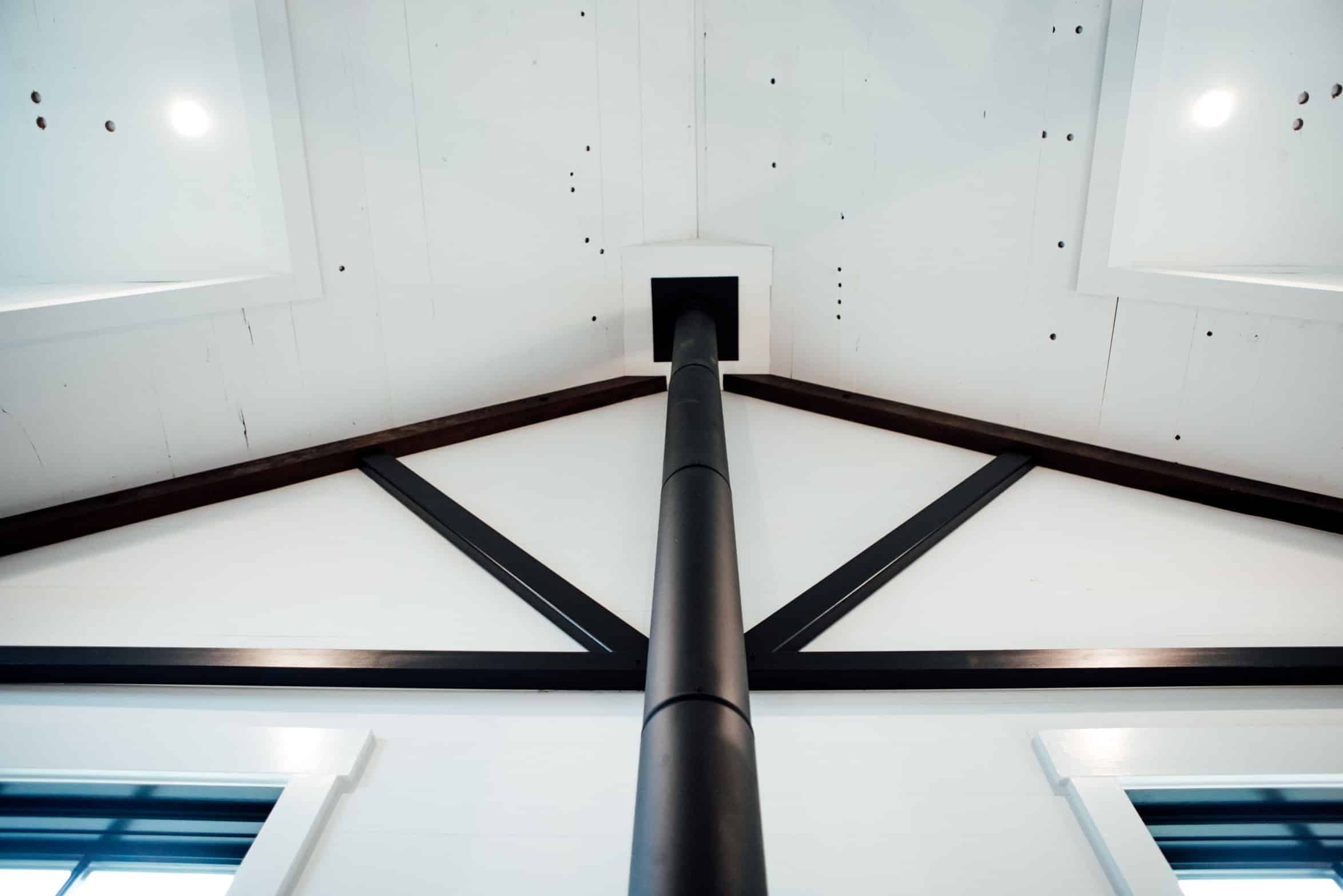 vaulted ceiling with wood beams on back wall Cochrans Lumber