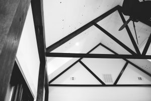 black and white image of vaulted ceiling with wood beams