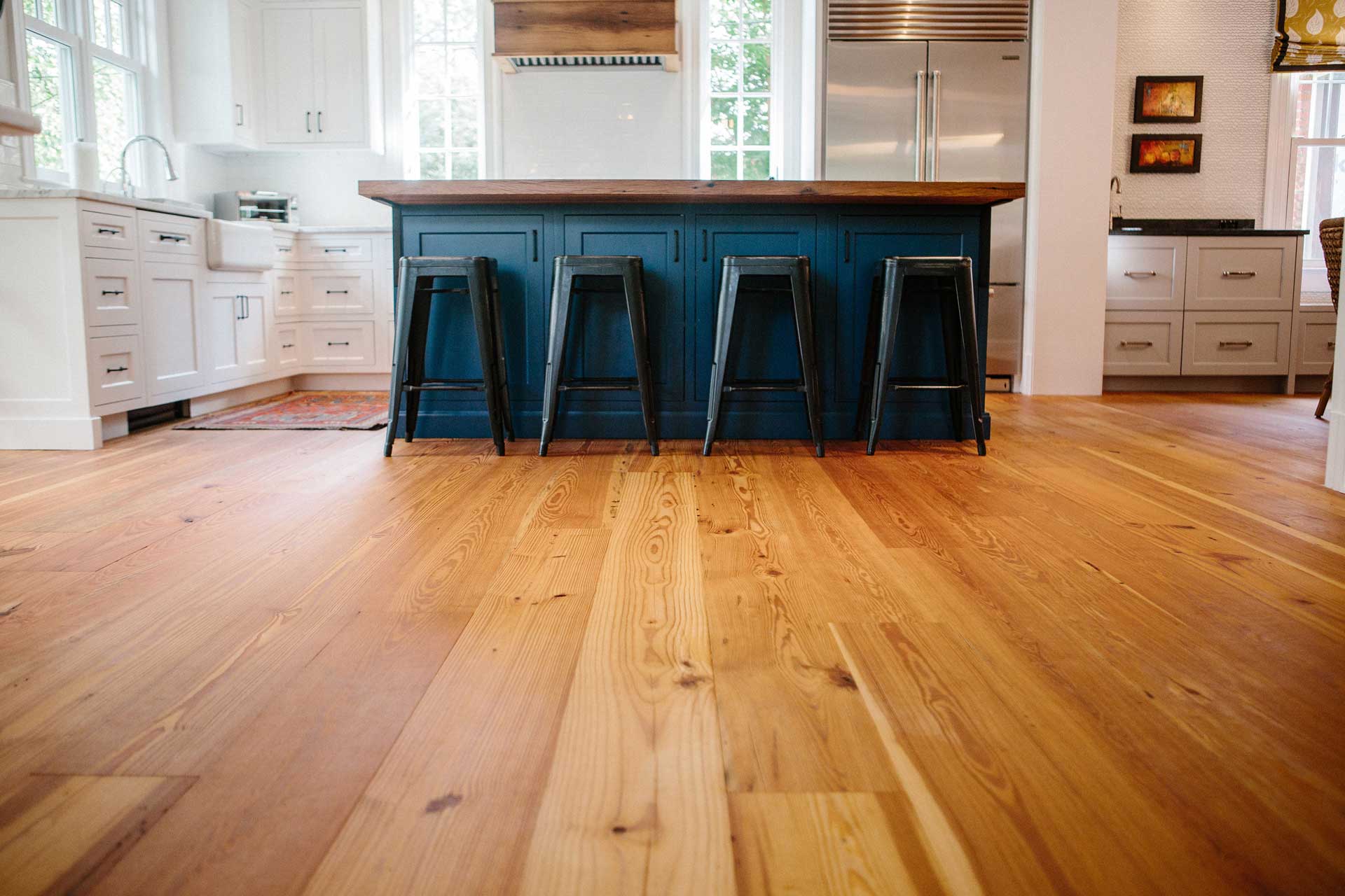 Image of Wide plank heart pine flooring in kitchen at Hendy by Finn Construction Company