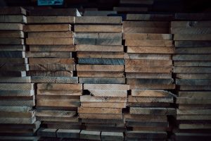 Rough-sawn planks of wood sitting in a neat stack